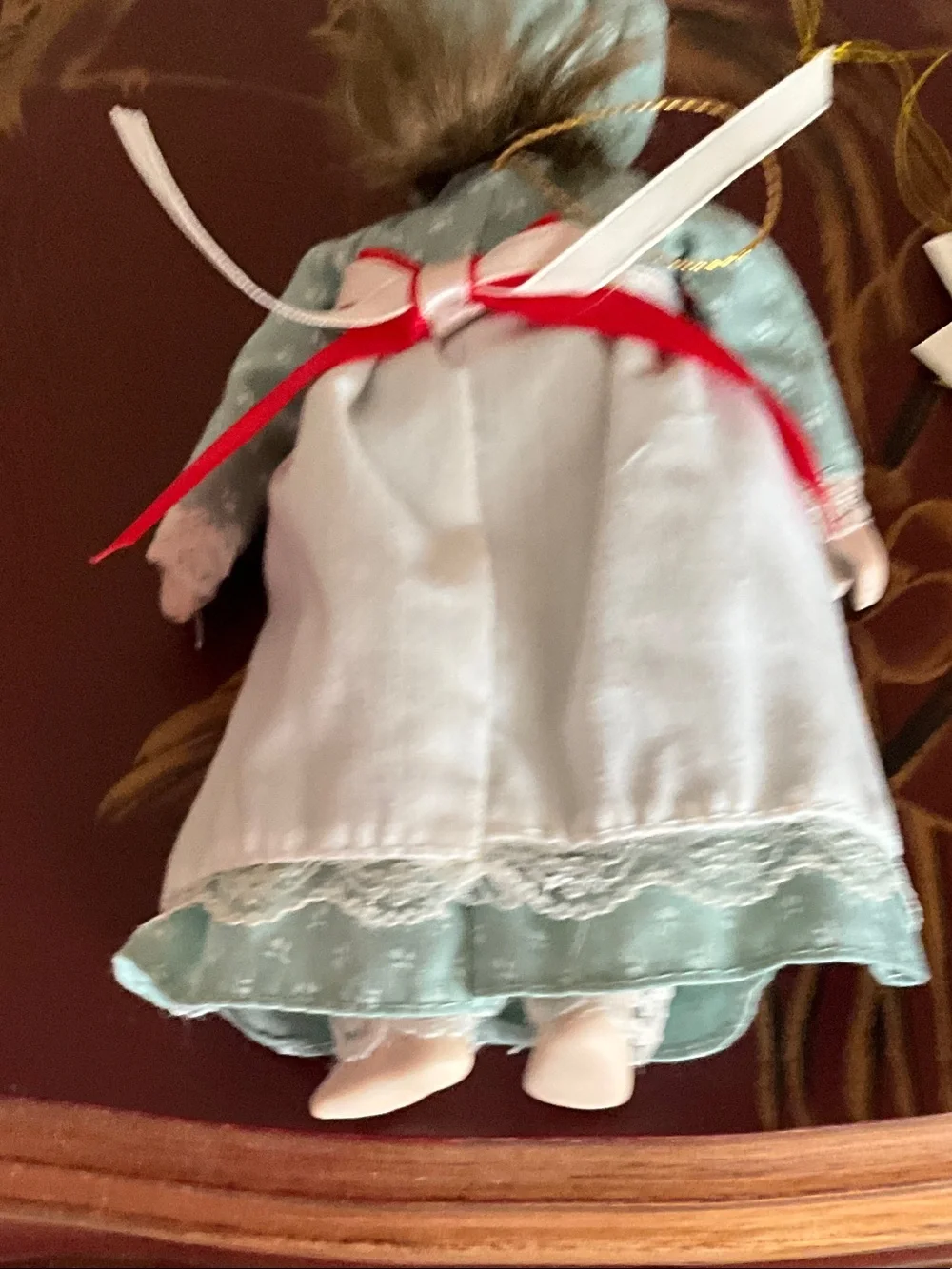 Porcelain Doll in Light Blue Dress with Red Ribbon Accents